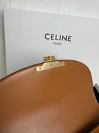 Tan leather bag top with hinged gold-toned closure hardware