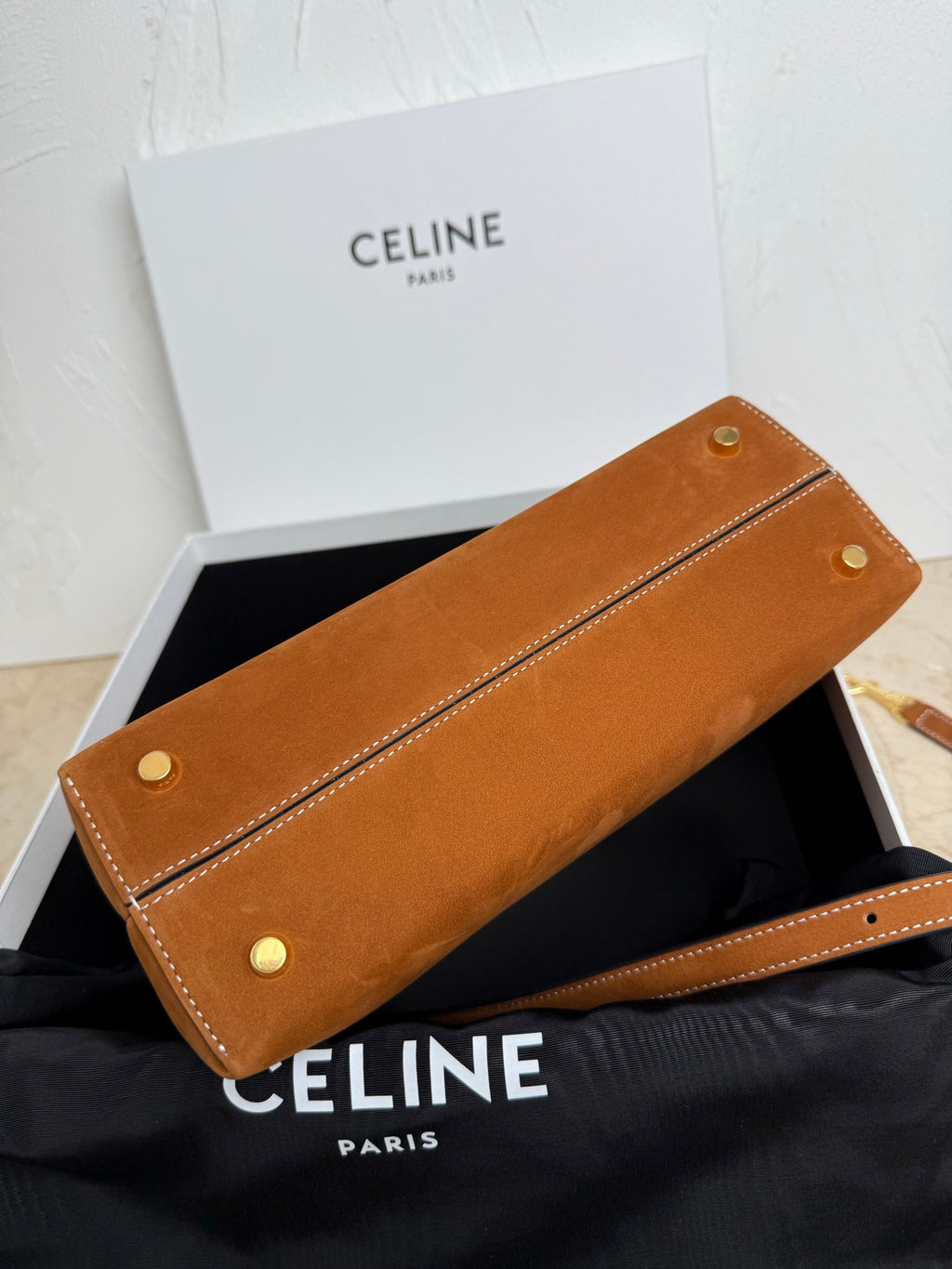 Tan leather long clutch with two snap buttons and stitched edges