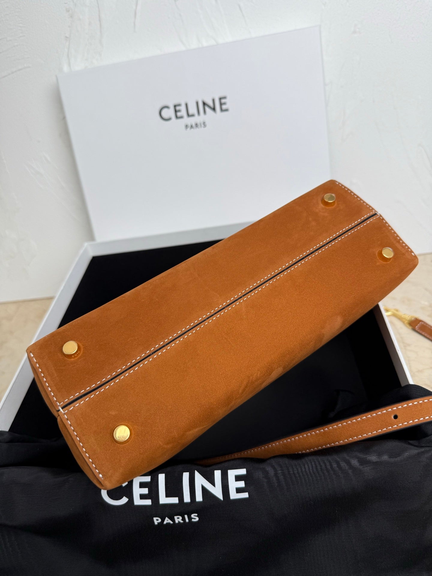 Tan leather long clutch with two snap buttons and stitched edges