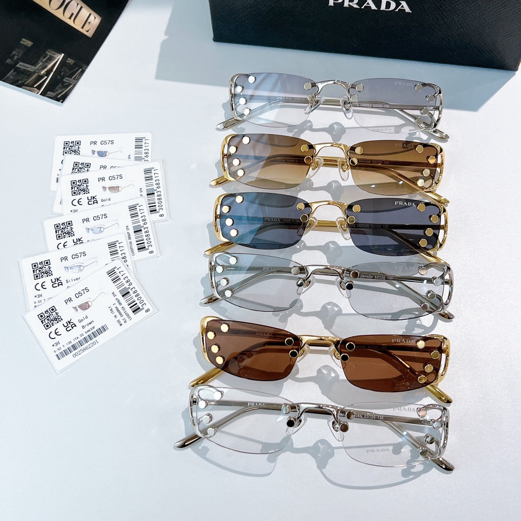 Prada glasses set with multiple metal frames and tinted lenses, laid out side by side