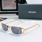 Prada glasses with blue tint lenses and gold-tone metal frames, curved rectangular design