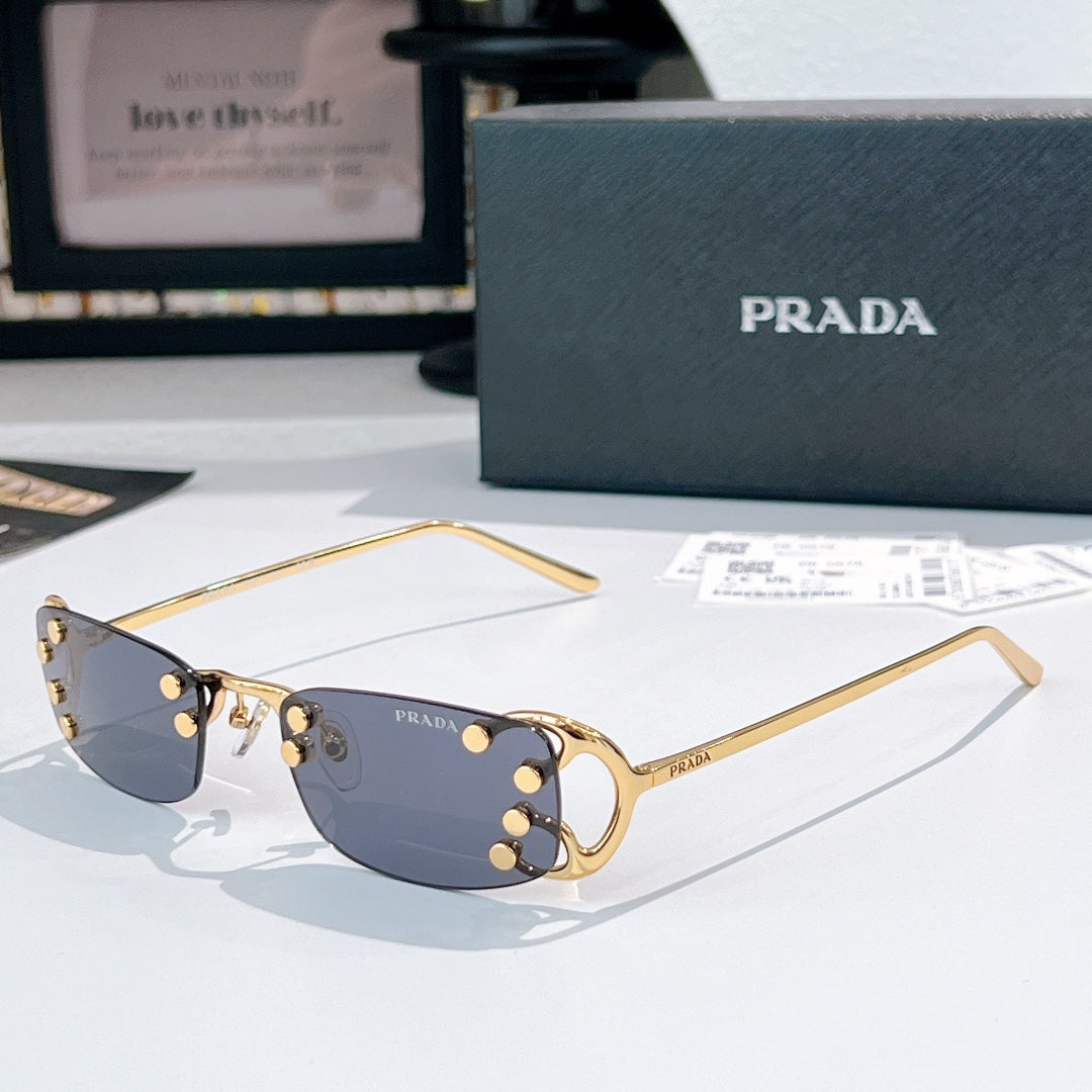 Prada glasses with blue tint lenses and gold-tone metal frames, curved rectangular design