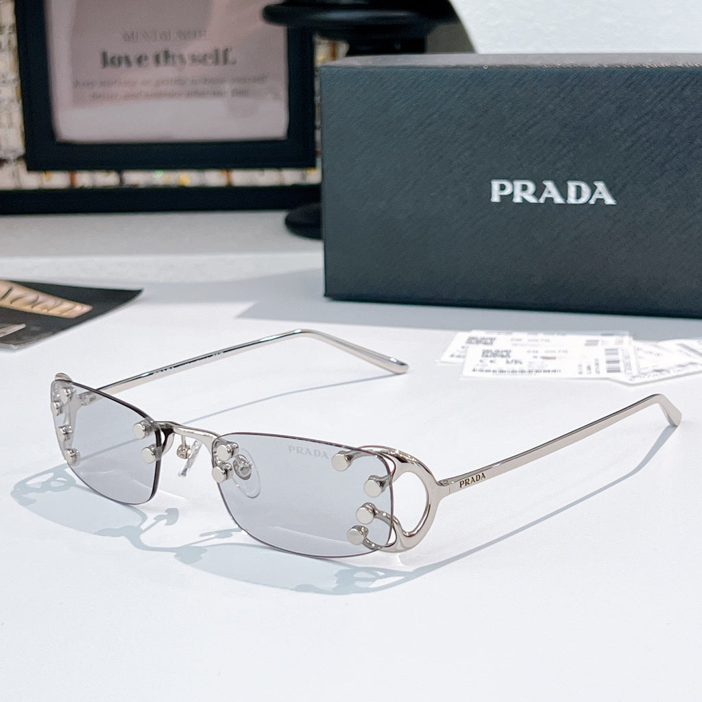 Prada glasses with clear lenses and silver-tone metal frames, curved rectangular design