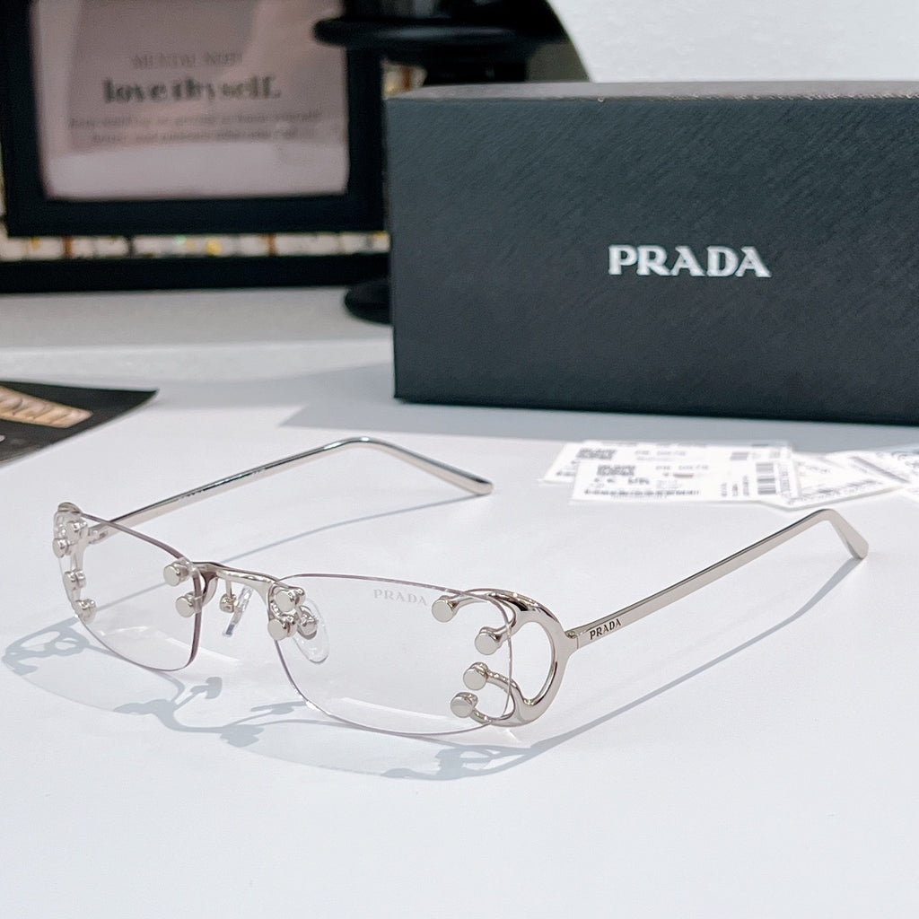 Prada glasses with clear lenses and silver-tone metal frames, front view with metal details