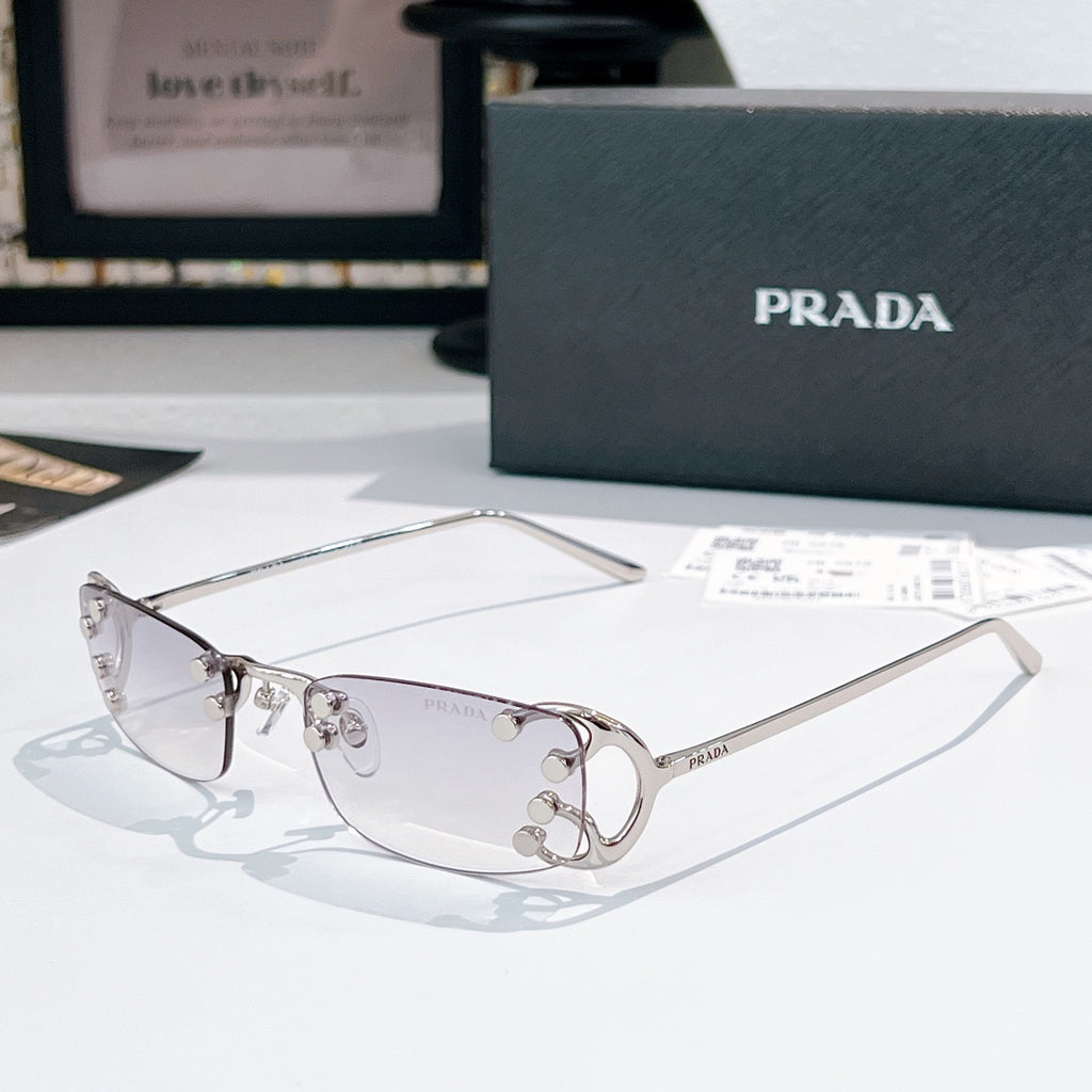 Prada glasses with clear lenses and silver-tone metal frames, curved rectangular design