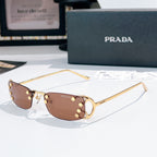 Prada glasses with brown lenses and gold-tone metal frames, curved rectangular design