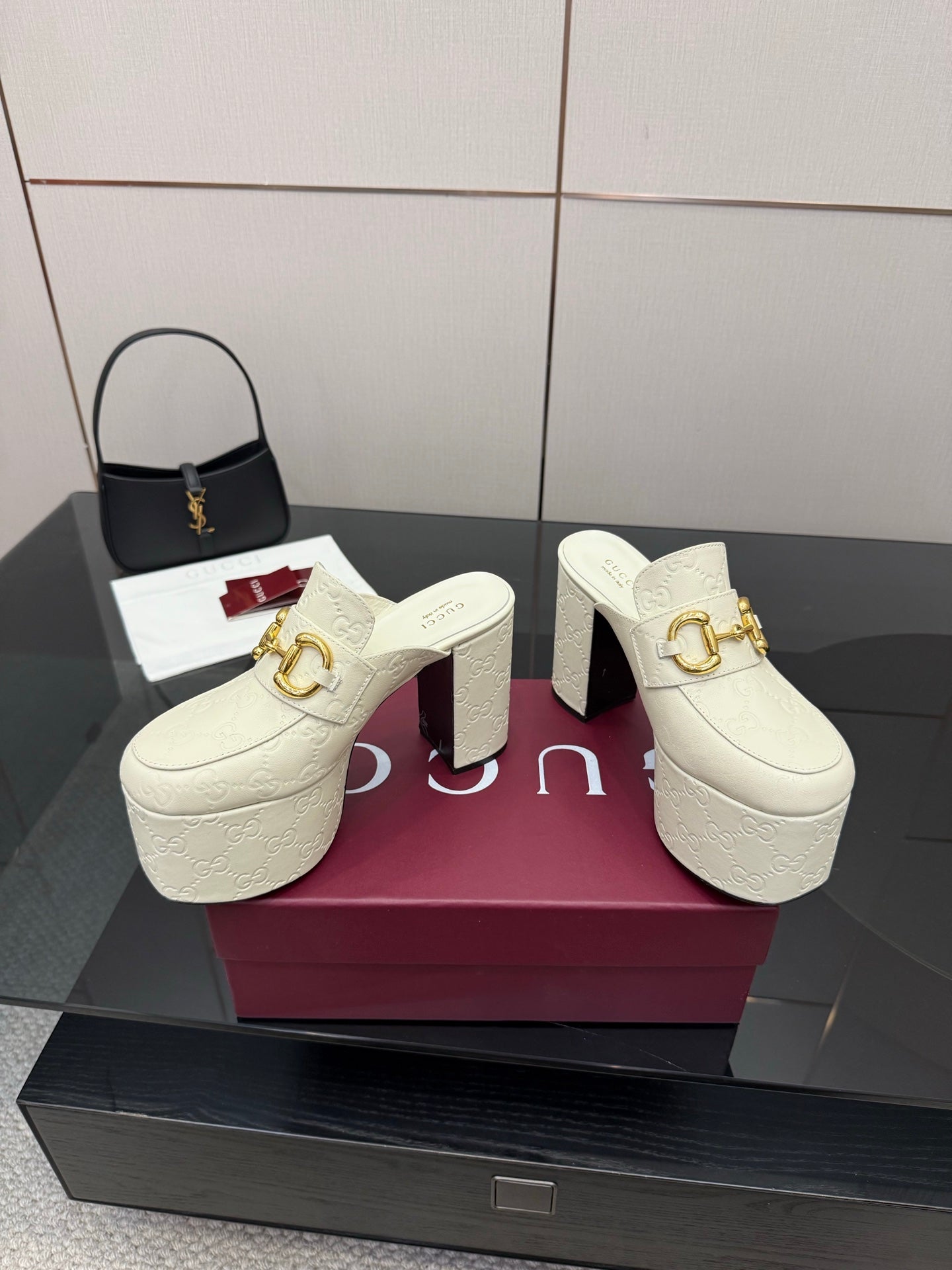 Gucci women’s platform mules, cream slip-on with gold buckle hardware
