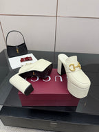 Gucci women’s platform mules pair, cream slip-ons with gold buckle on block heels