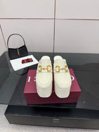 Gucci women’s platform mules, cream leather with gold buckle detail