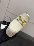 Gucci women’s platform mules, cream leather with gold double-buckle detail