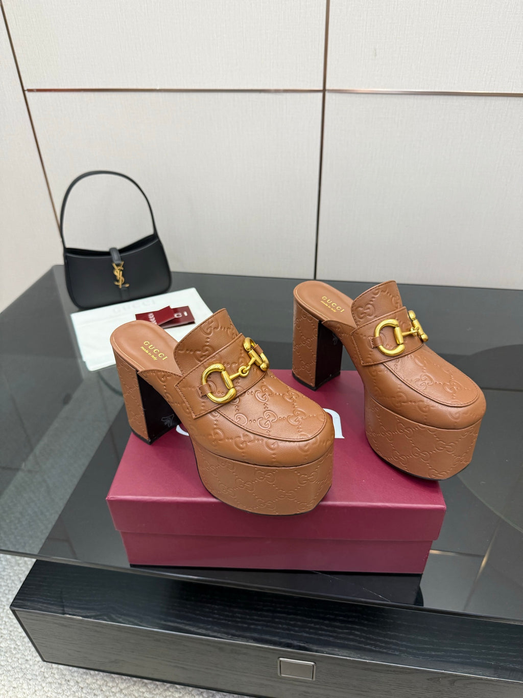 Tan/brown embossed platform mule slides with thick block heels and gold double-buckle detail