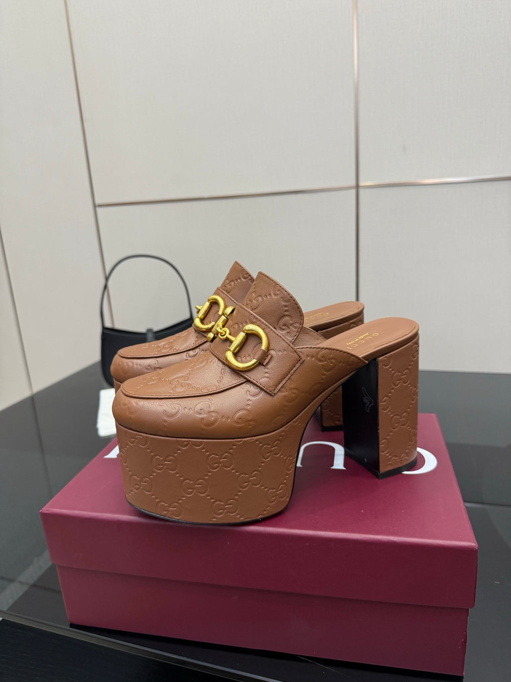 Tan/brown embossed platform mule with gold double-buckle strap and chunky stacked heel
