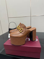 Tan/brown embossed platform mule with gold double-buckle strap and chunky stacked heel
