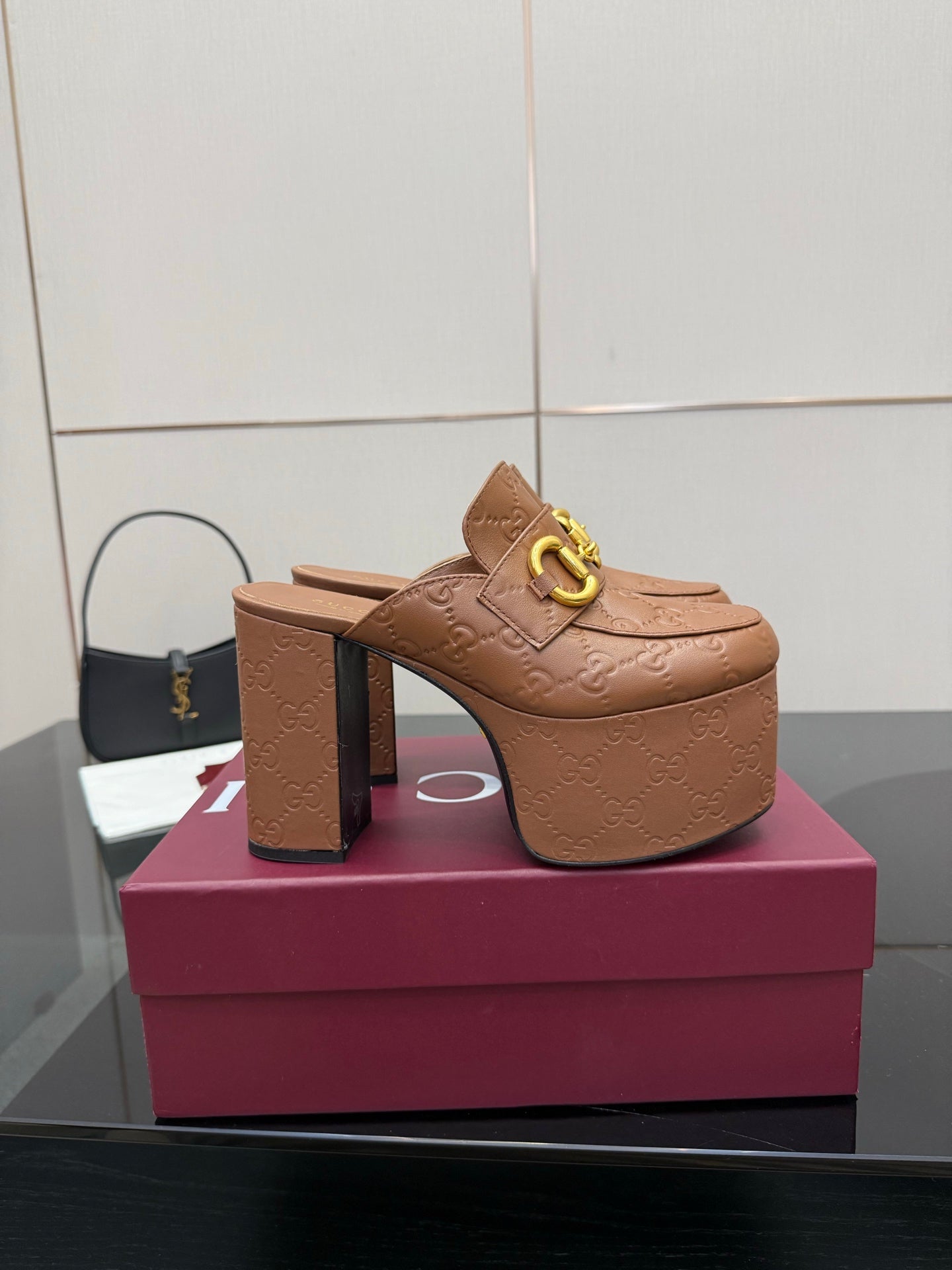 Tan/brown embossed mule sandal with open back, high platform sole, and gold buckle