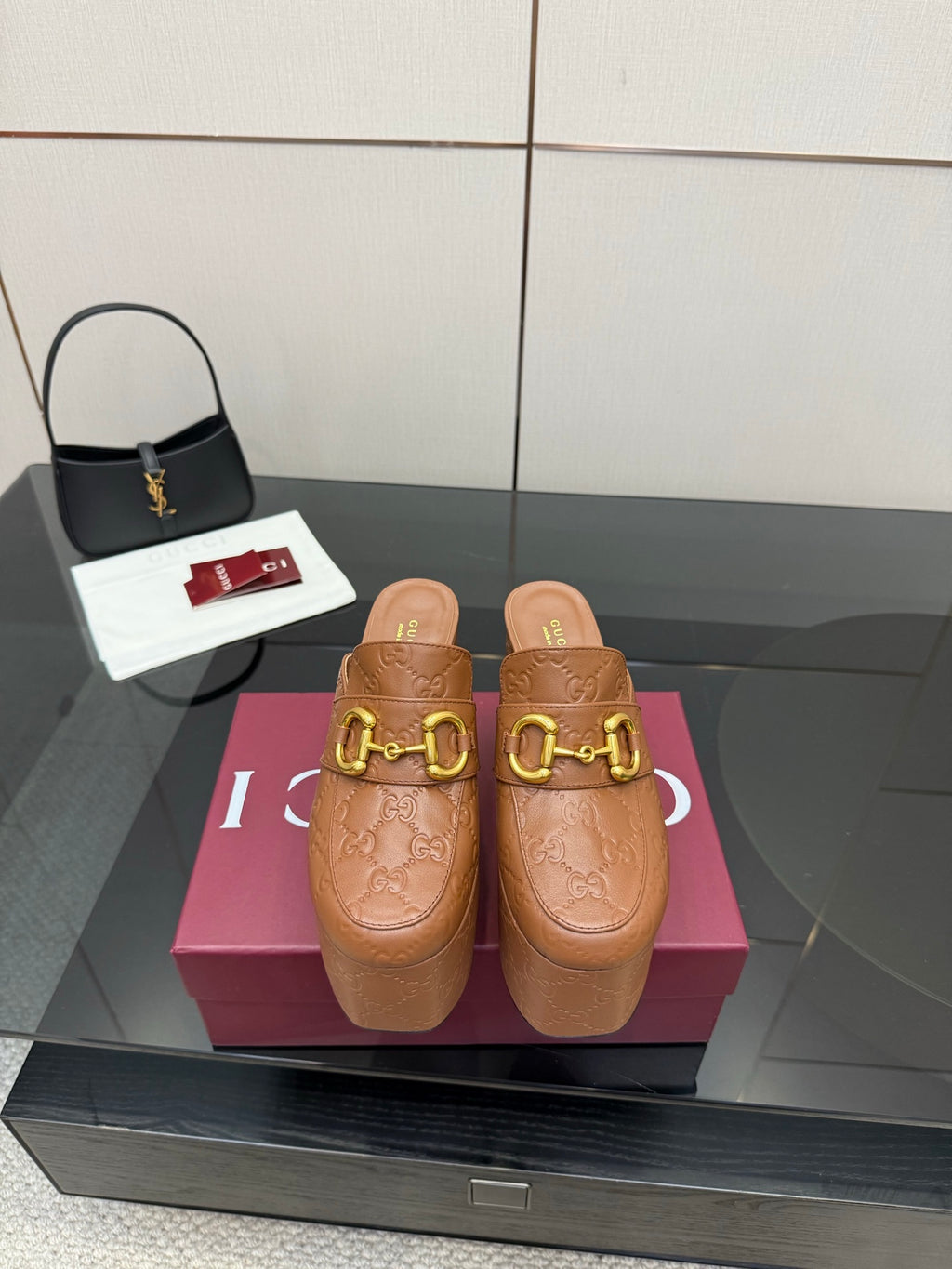 Women’s platform mule heels in tan/brown embossed leather with gold double-buckle strap