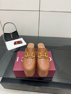 Women’s platform mule heels in tan/brown embossed leather with gold double-buckle strap