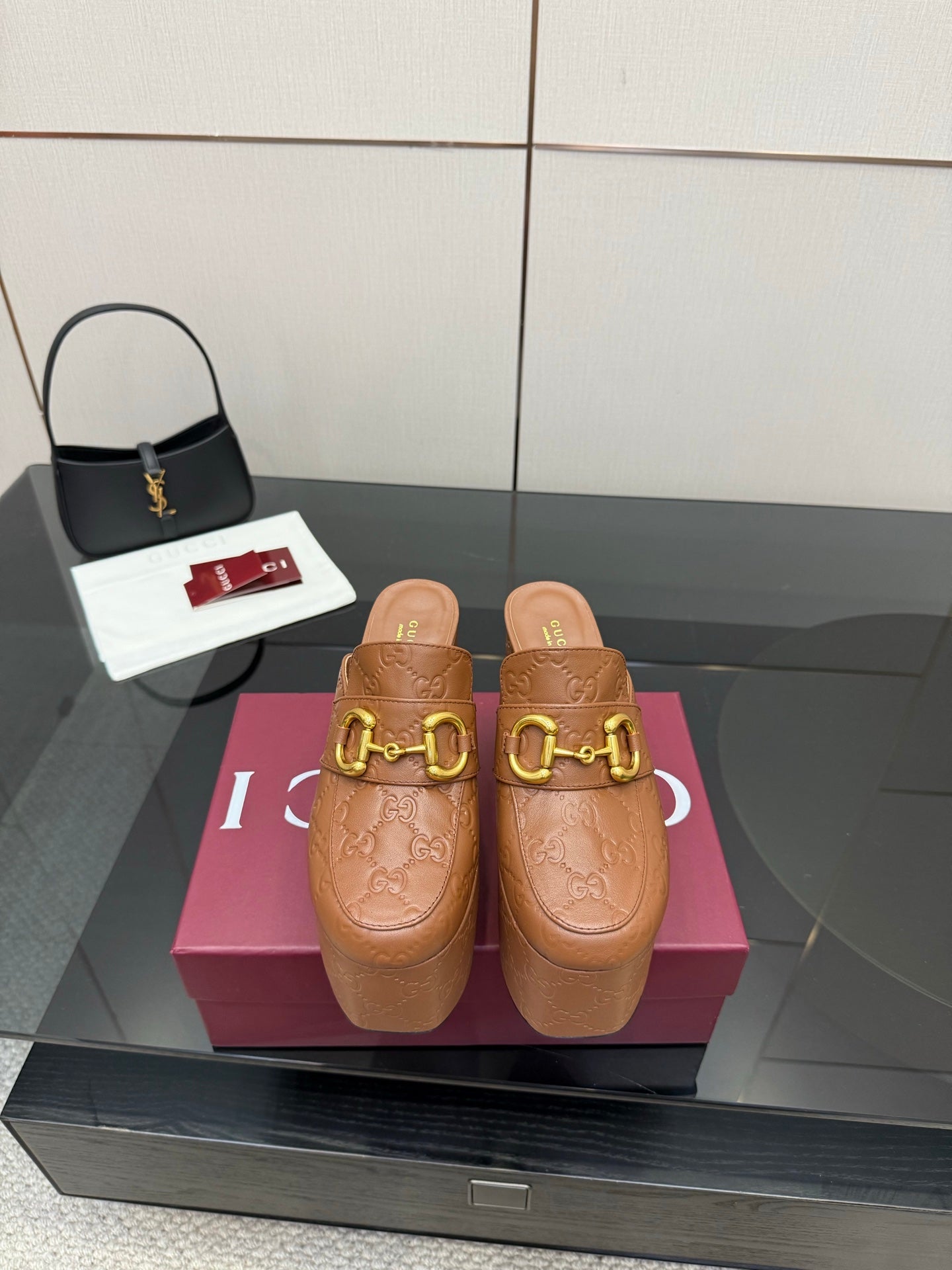 Women’s platform mule heels in tan/brown embossed leather with gold double-buckle strap