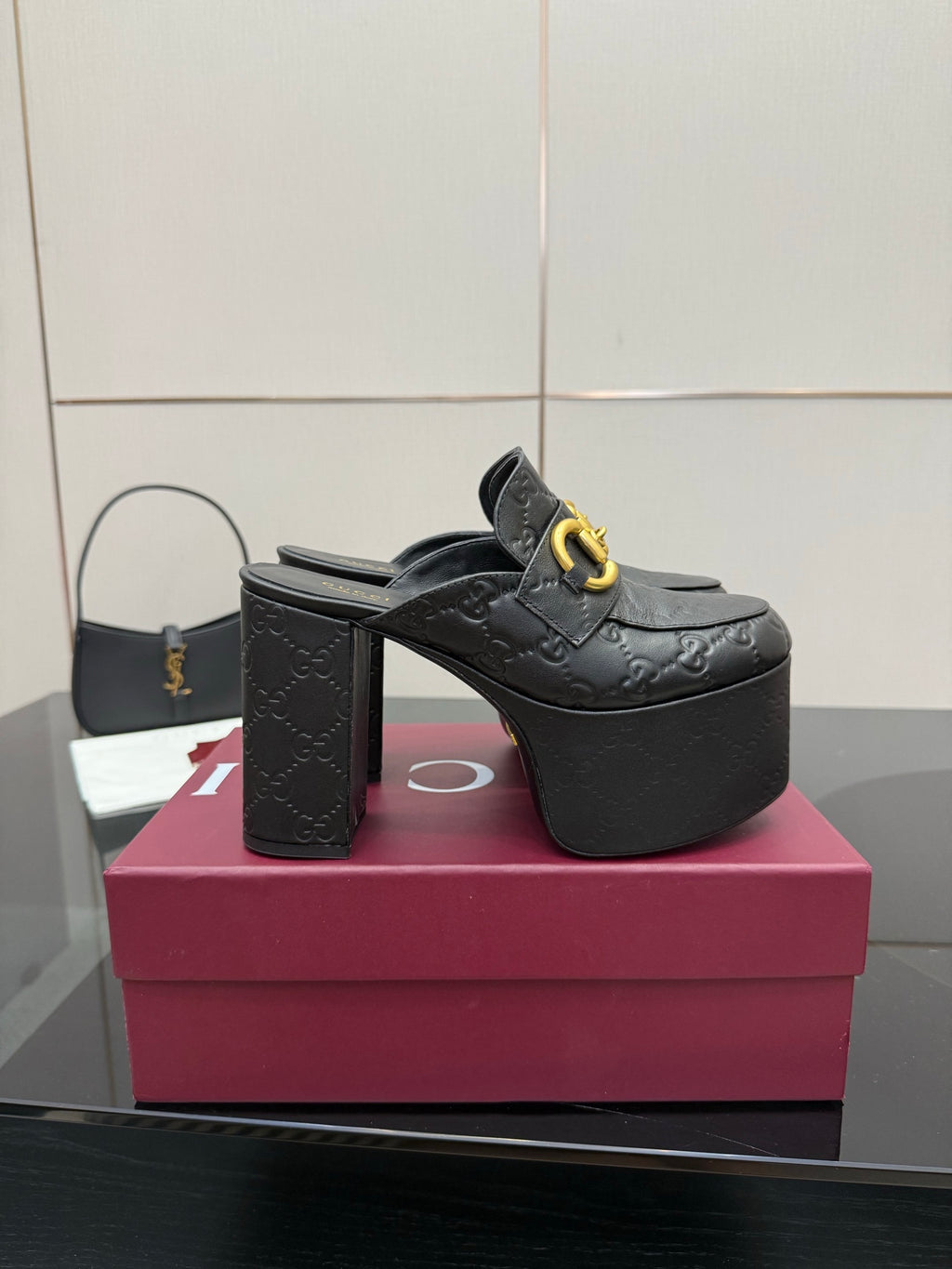 Black Gucci platform mule with gold buckle strap and high block heel
