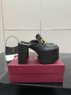Black Gucci platform mule with gold buckle strap and high block heel