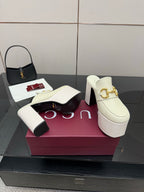 Gucci ladies off-white mule clogs with gold logo hardware, thick platform, and block heel