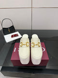Gucci ladies platform mule clogs in off-white with gold logo hardware and thick heel