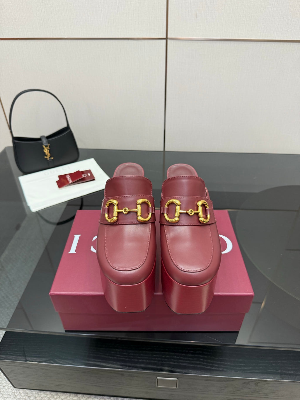 Burgundy Gucci platform mules with gold horsebit buckle and chunky heel