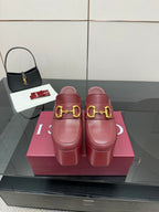 Burgundy Gucci platform mules with gold horsebit buckle and chunky heel