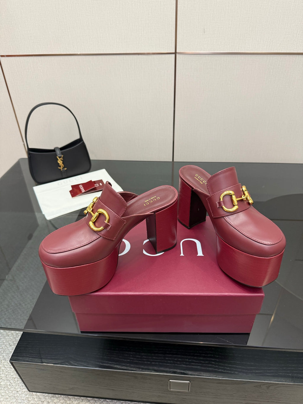 Burgundy Gucci platform mules with gold horsebit detail, open mule style