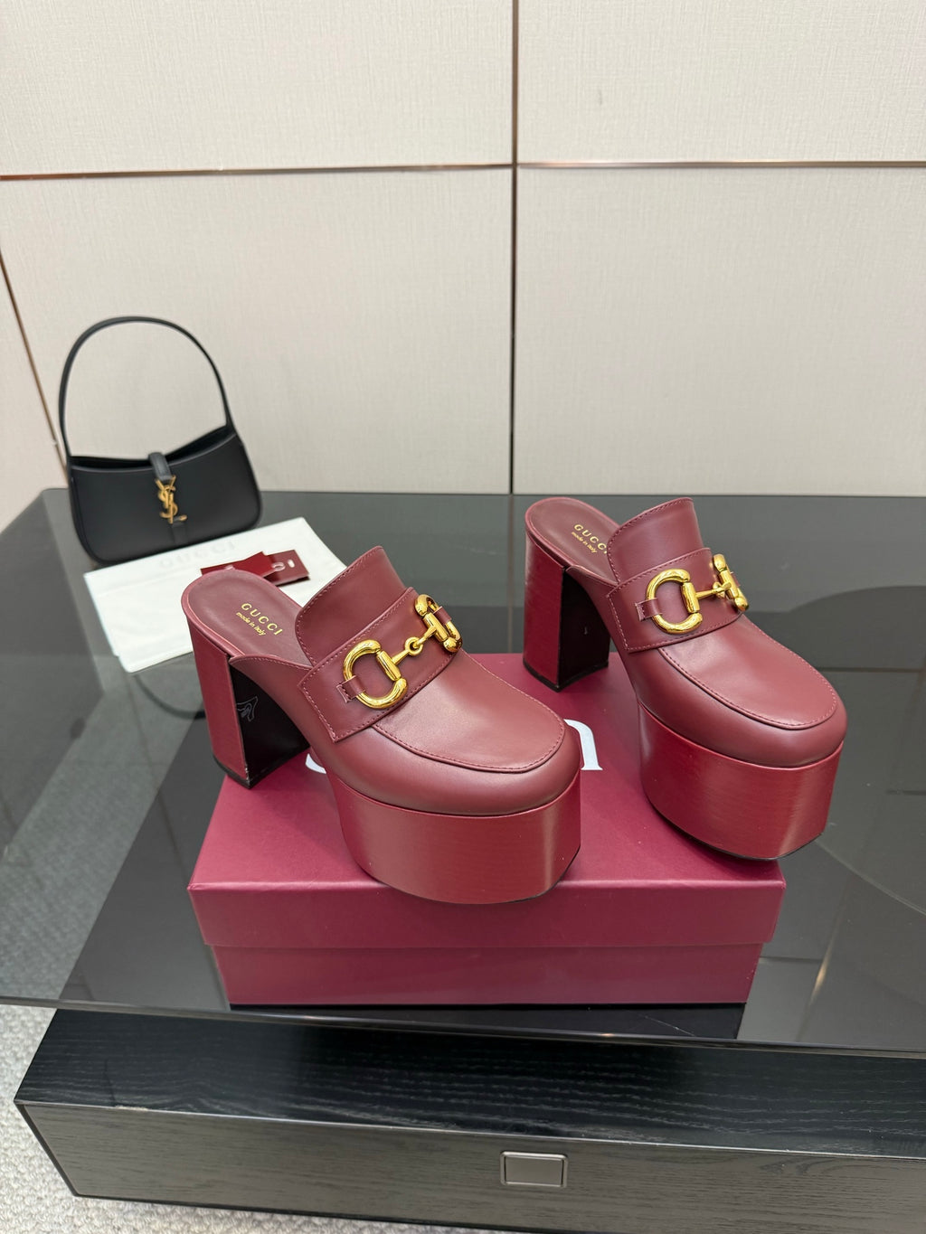 Burgundy Gucci mule clogs with gold horsebit buckle and stacked platform heel