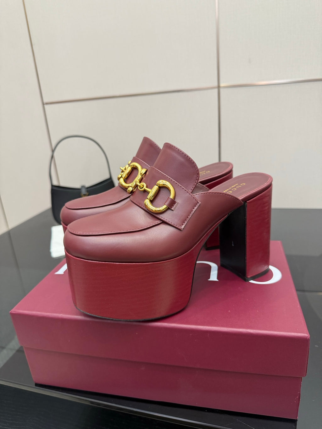 Burgundy Gucci mule with gold horsebit strap on thick platform heel