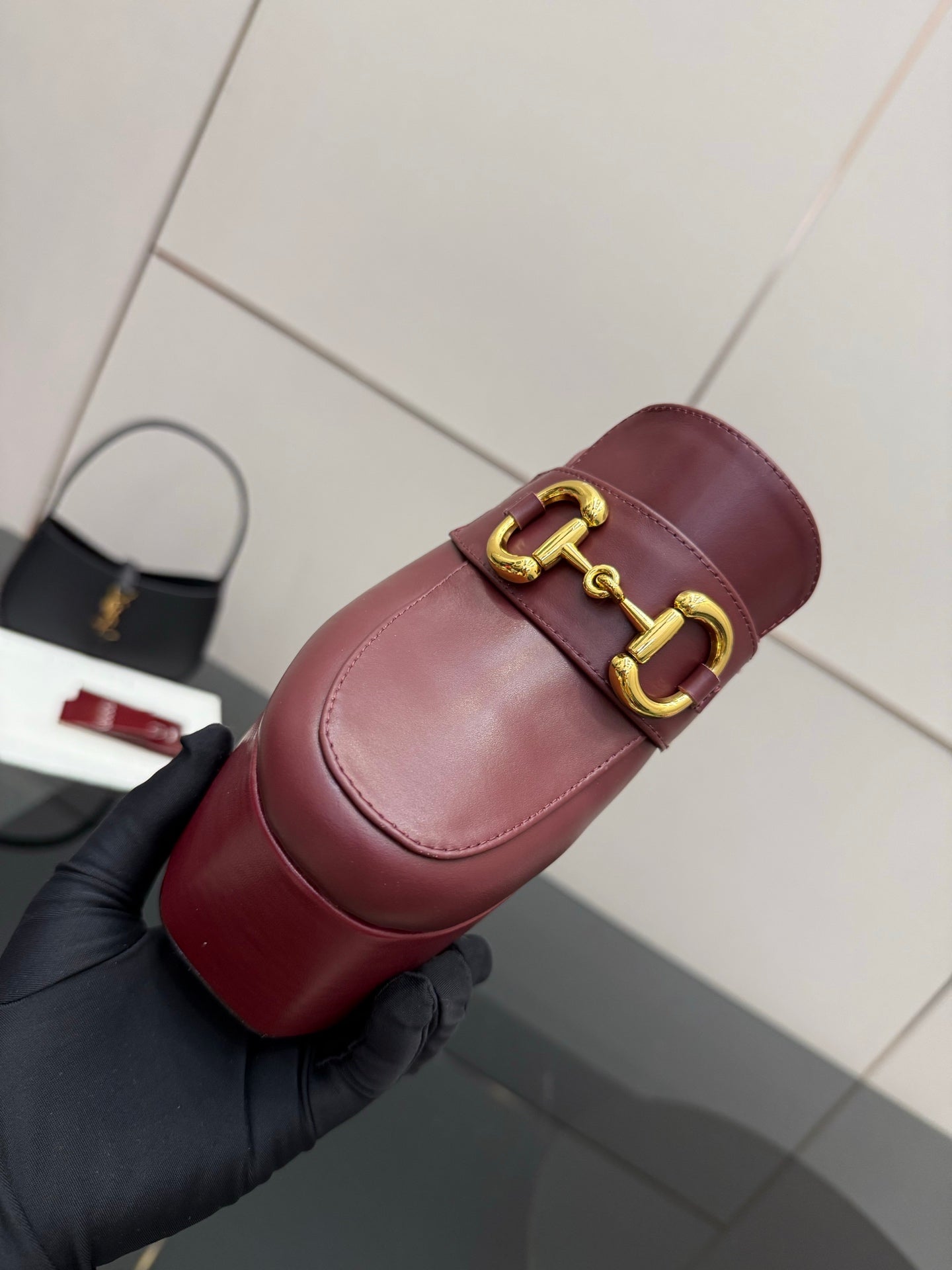 Burgundy Gucci mule clog with gold horsebit strap detail and padded insole
