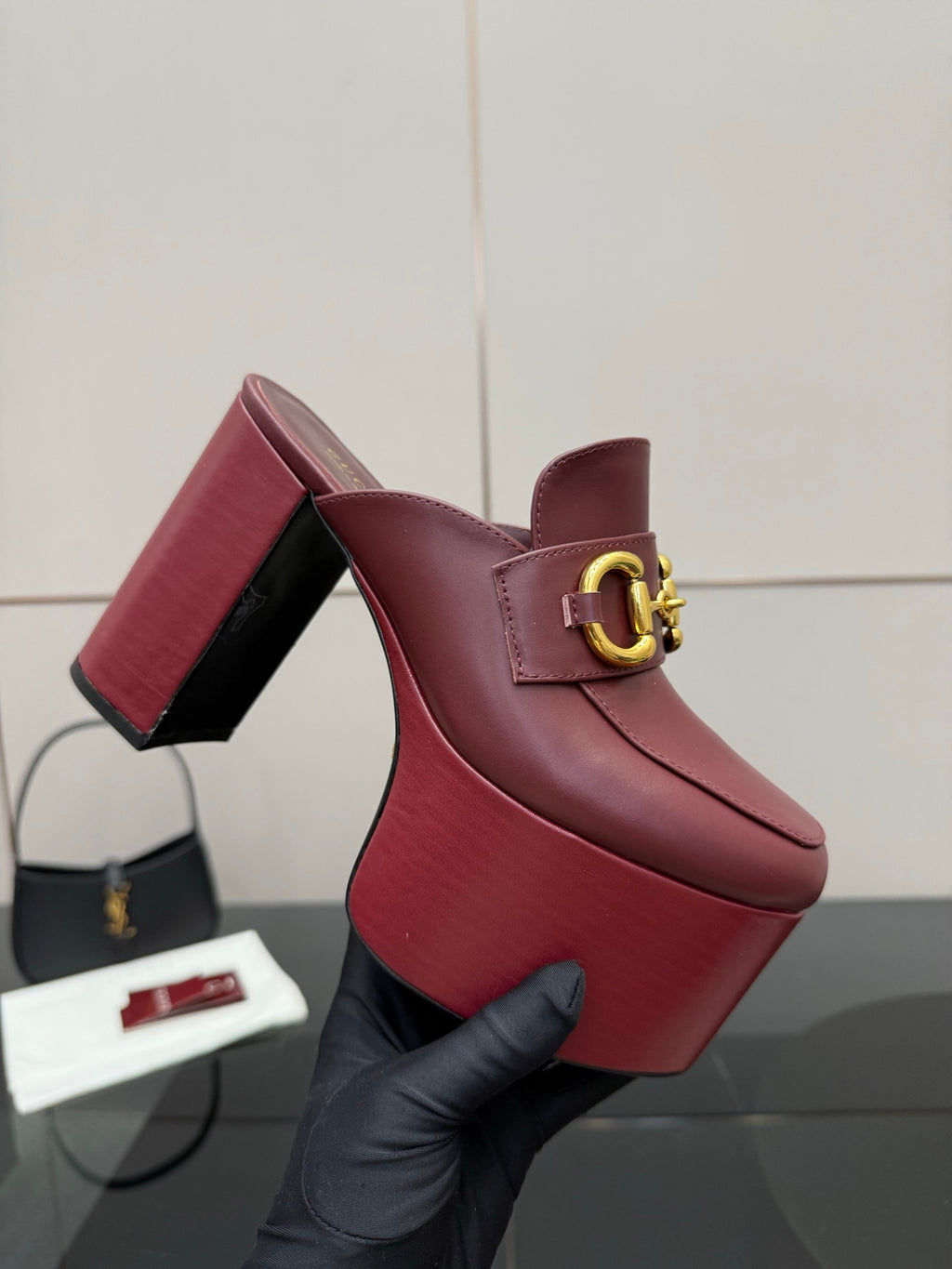 Burgundy Gucci platform mule with gold horsebit ornament and block heel