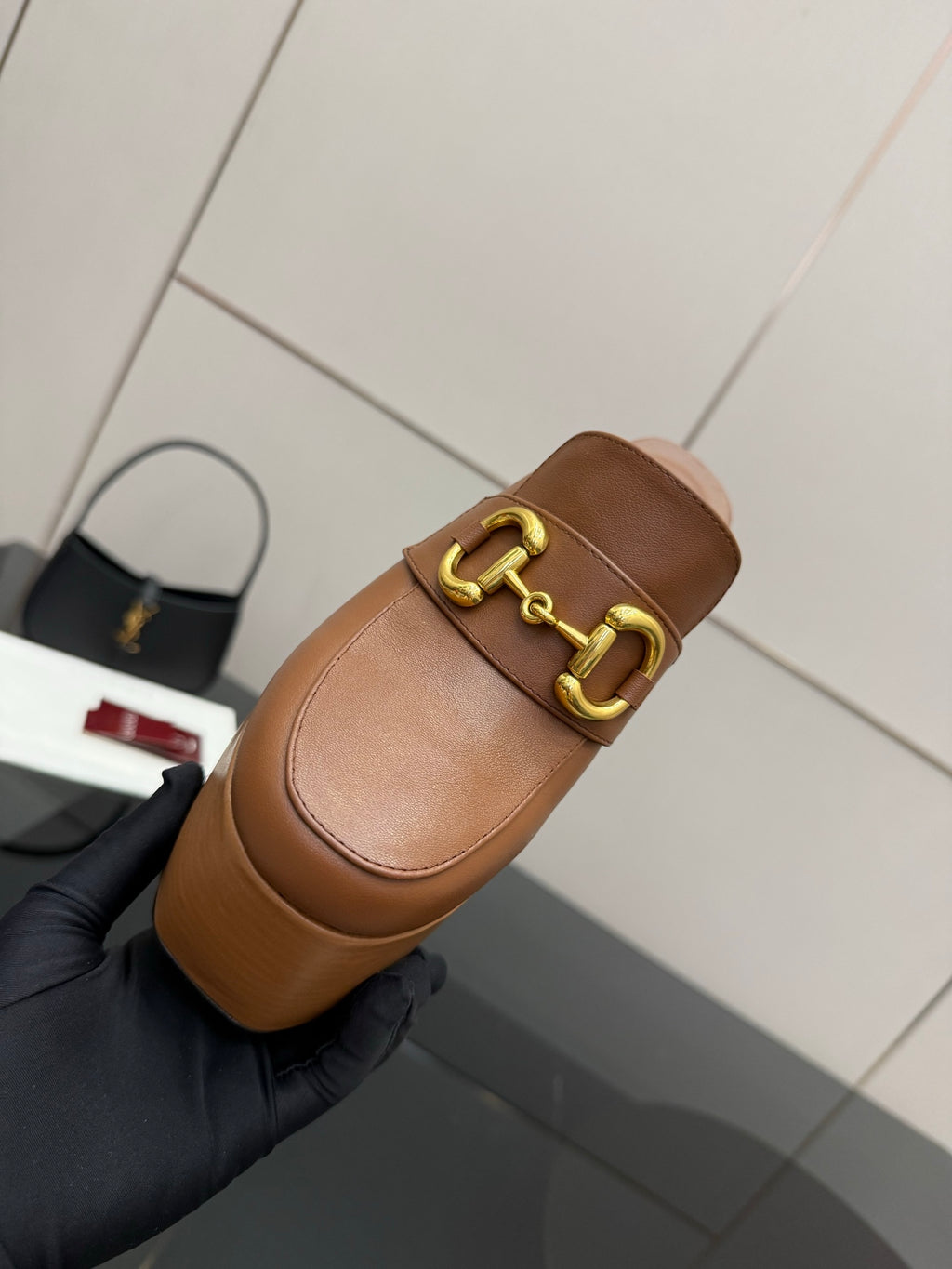 Gucci platform mule close-up, tan leather with gold Horsebit buckle