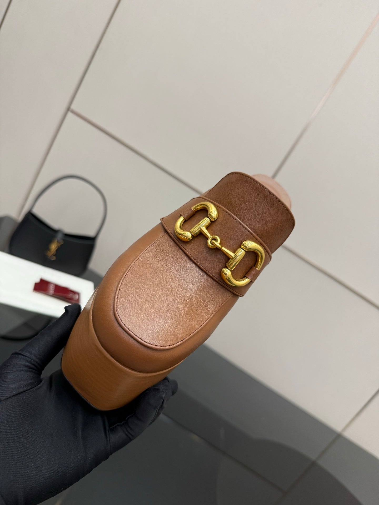 Gucci platform mule close-up, tan leather with gold Horsebit buckle