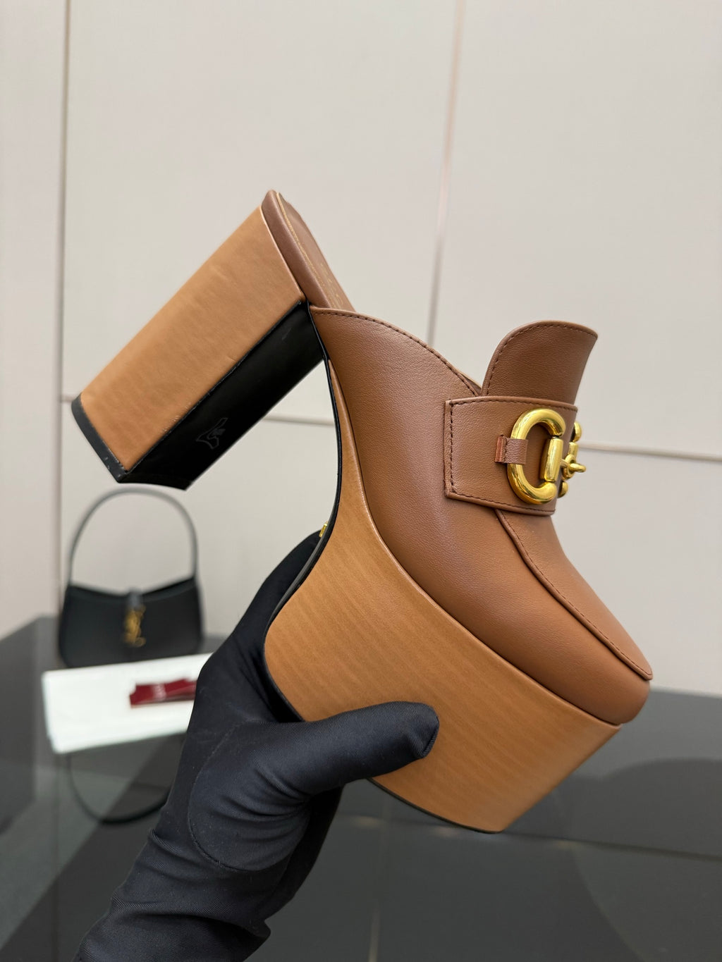 Gucci platform mule close-up, tan leather with gold Horsebit buckle and chunky heel