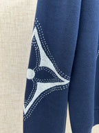 Navy hoodie sleeve with white emblem graphic and dotted lines