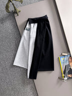 Two-piece outfit: grey skirt with black panel and matching long-sleeve top, hanging