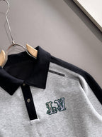 Close-up Louis Vuitton two-tone long-sleeve shirt with black collar and green logo