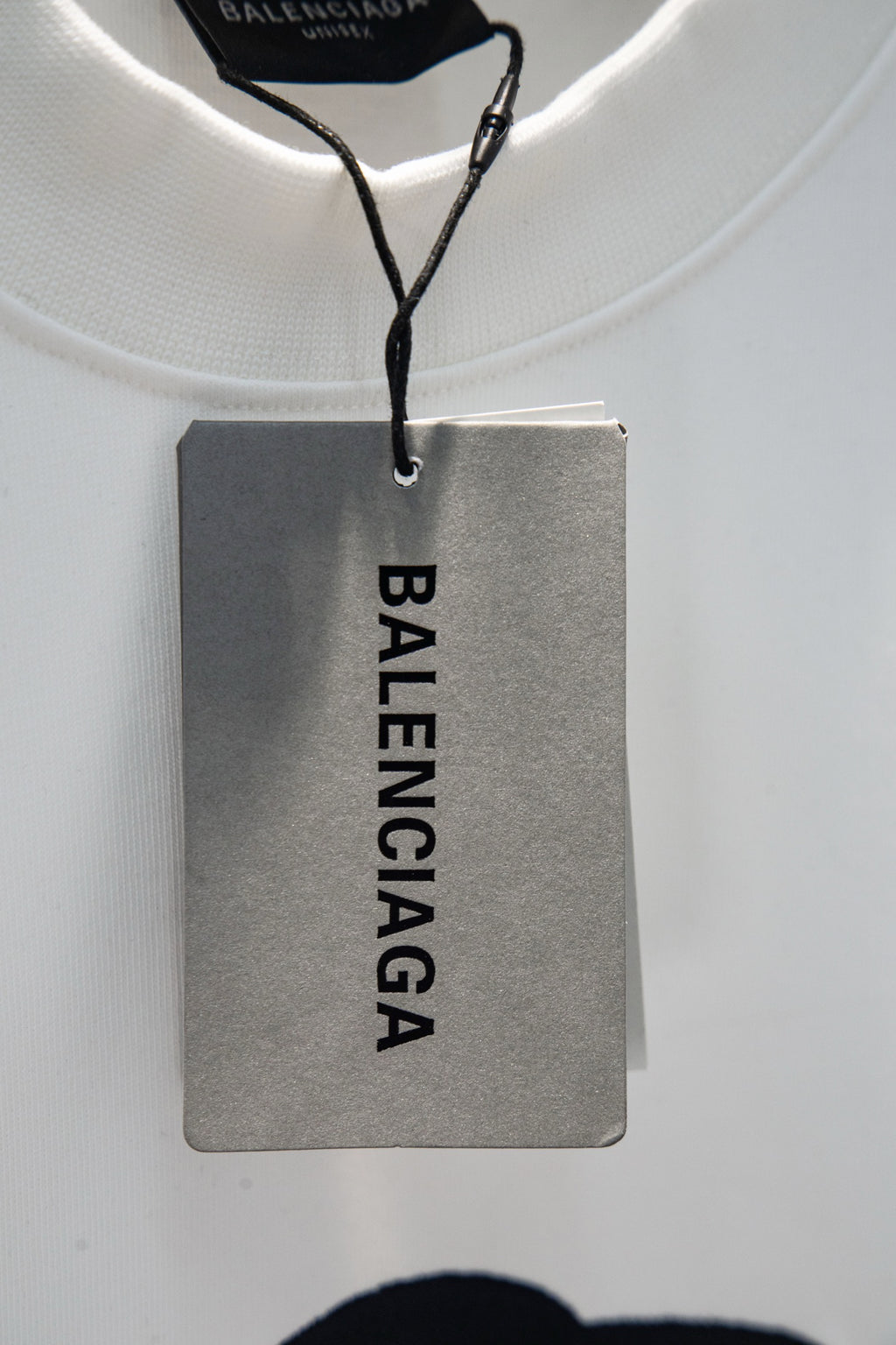 Balenciaga hang tag on white T-shirt collar