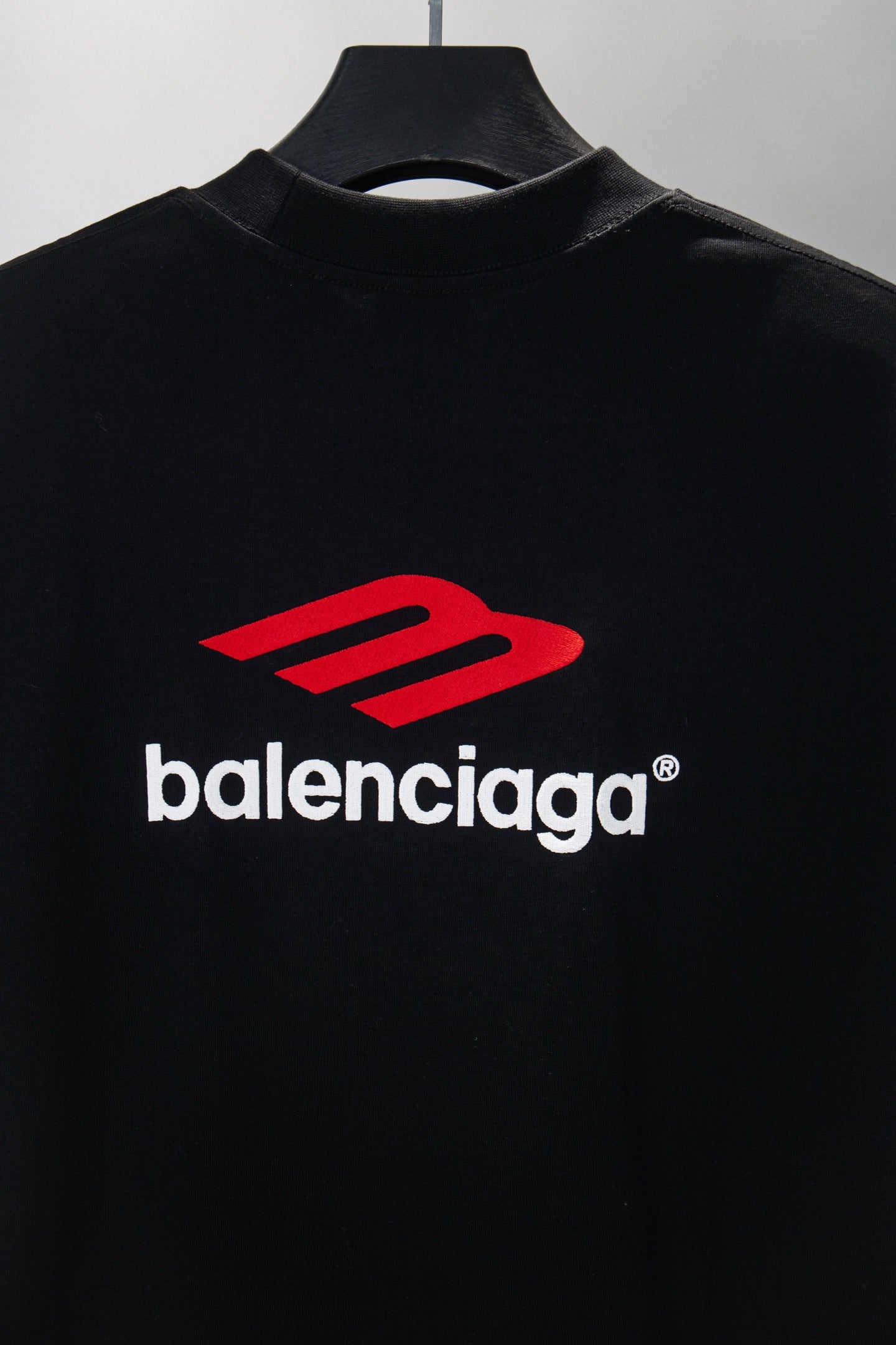 Black long-sleeve T-shirt with red Balenciaga emblem and logo text