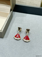 Pair of gold-tone earrings with red fan-style drops and rhinestone trim