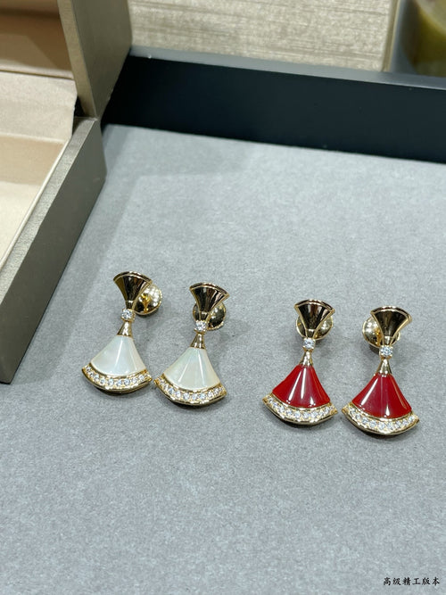 Gold-tone dangle earrings set with white and red fan-style drops and rhinestone edges