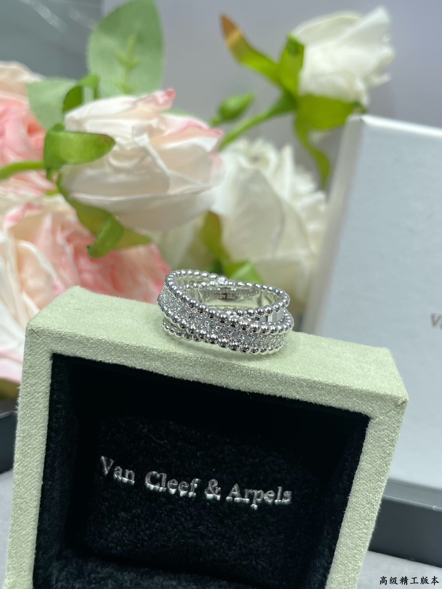 Silver-tone pavé ring on green jewelry box, wide band with stacked stones