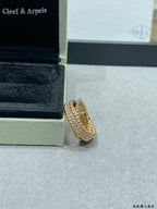 Gold-tone pavé wide ring with stacked stone rows on display surface