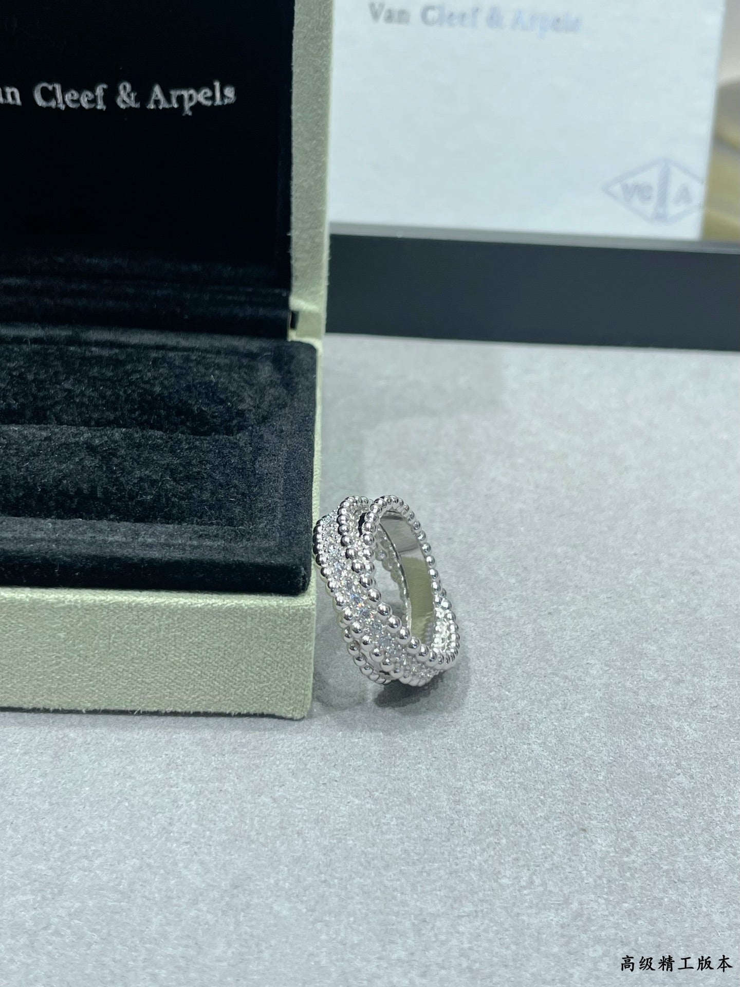 Silver-tone pavé wide ring with stacked stone rows on display surface