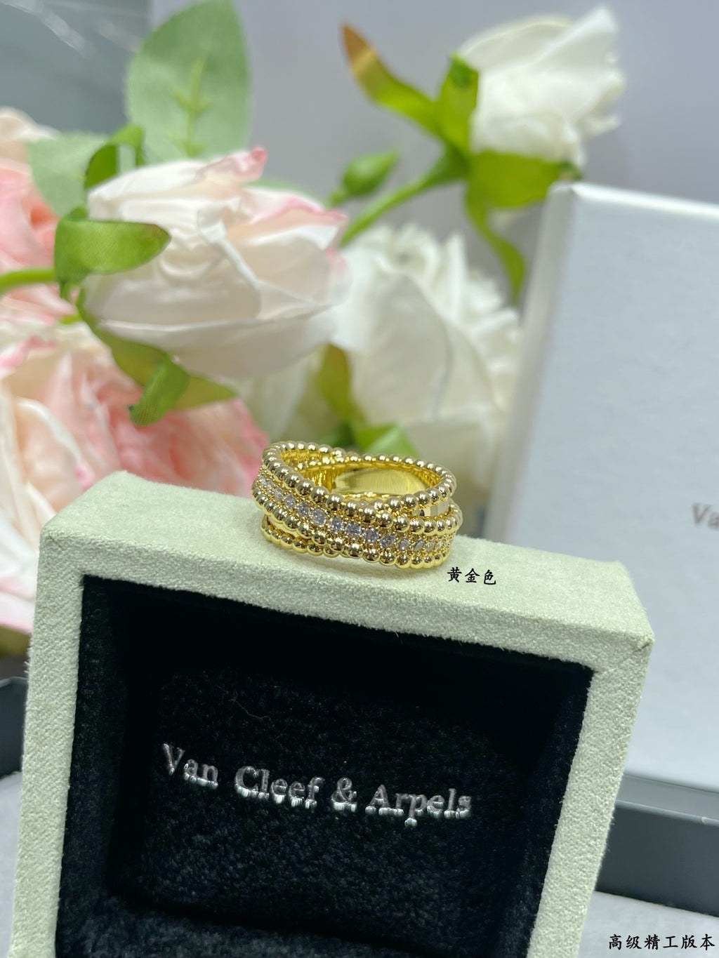 Gold-tone wide pavé ring with stacked stone rows on jewelry box
