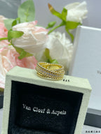 Gold-tone wide pavé ring with stacked stone rows on jewelry box