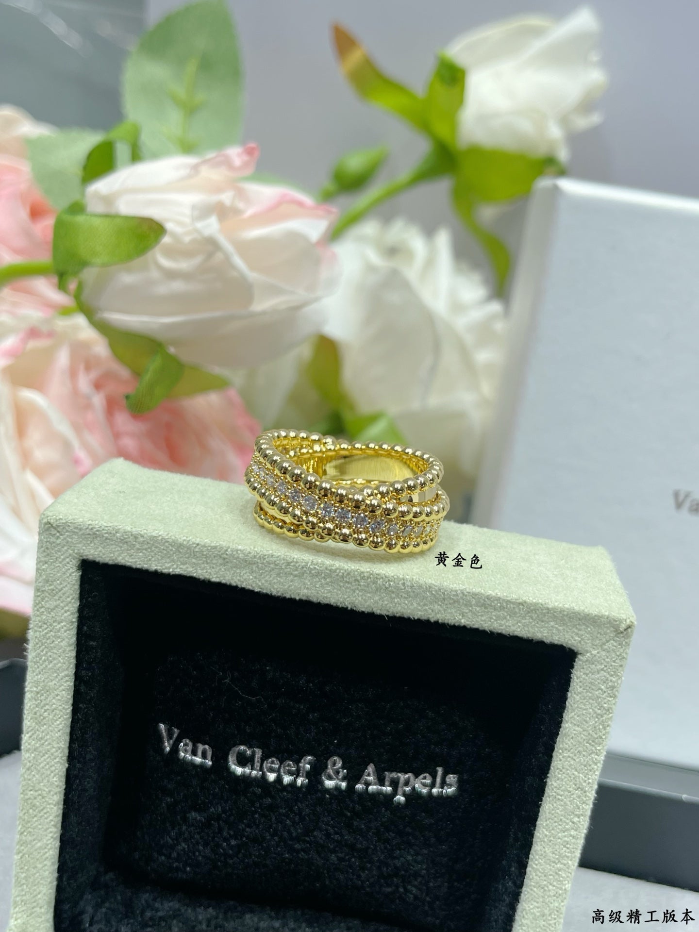 Gold-tone wide pavé ring with stacked stone rows on jewelry box