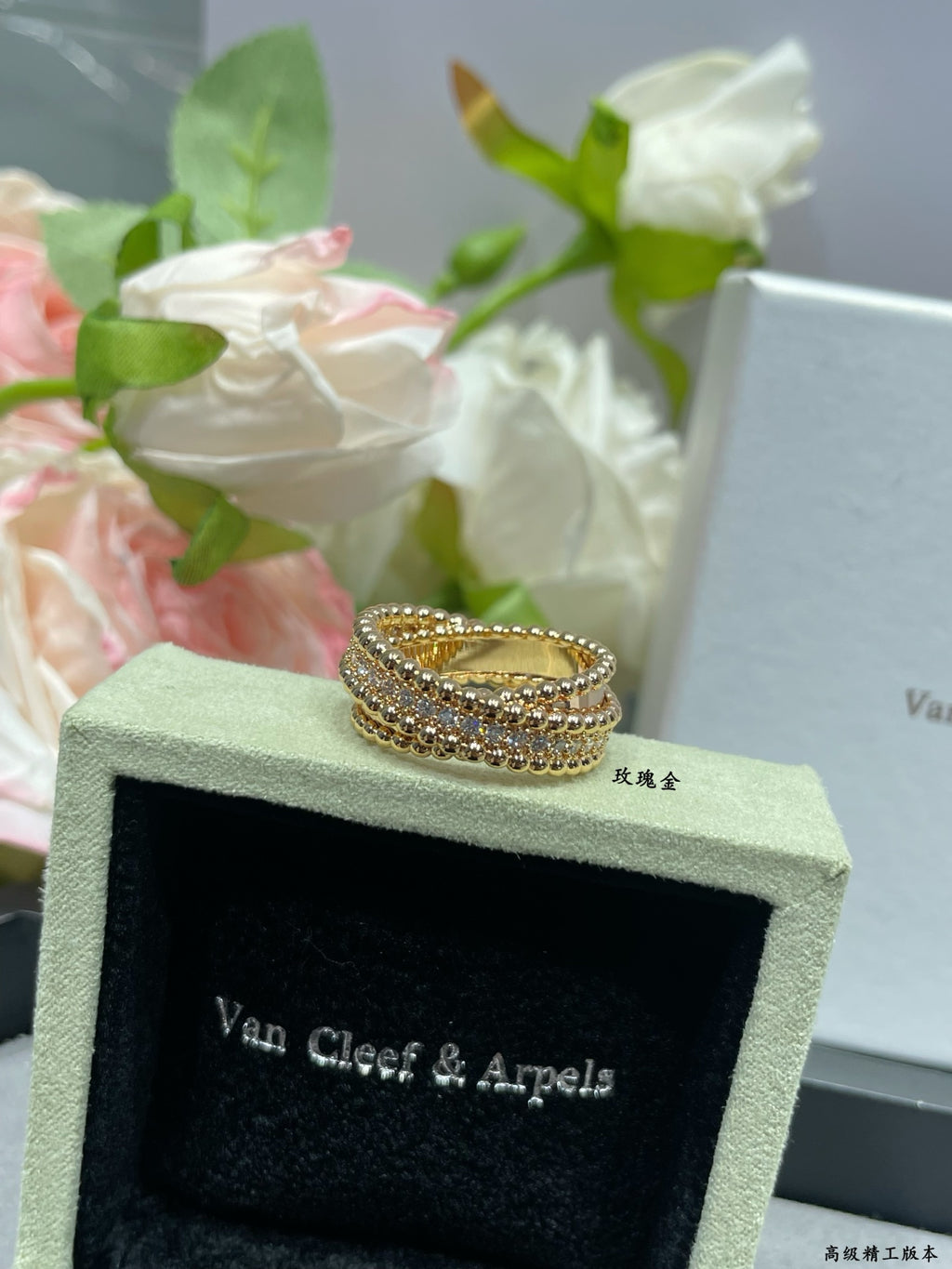 Gold-tone pavé ring on green jewelry box, wide band with sparkle rows