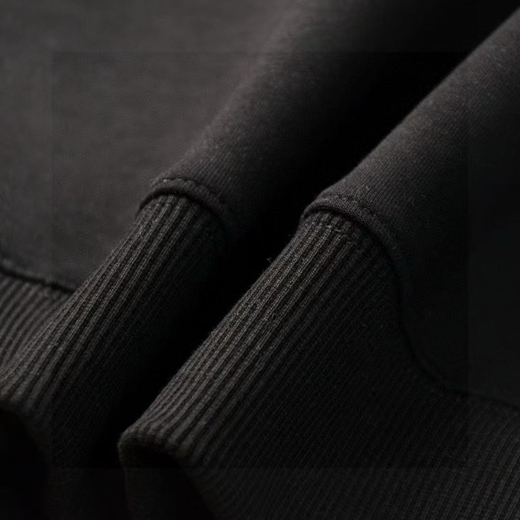 Ribbed knit cuff on dark sweatshirt sleeve